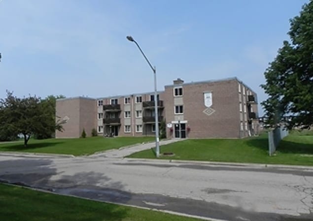 Image of a three storey apartment from a distance.