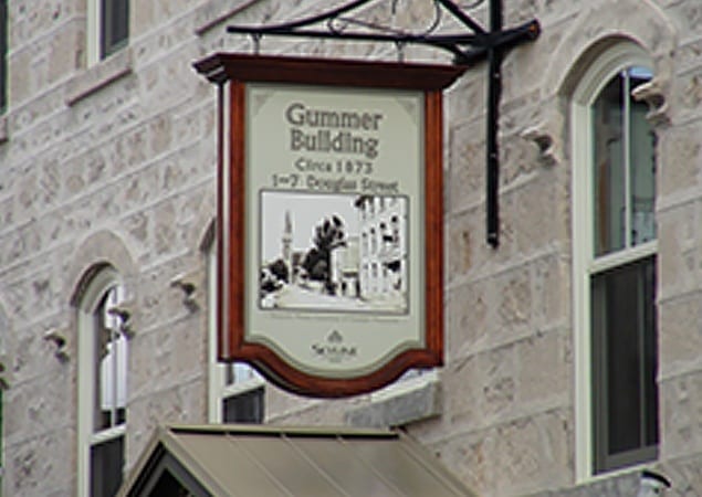 A sign showing the Gummer Building historic photo from 1918