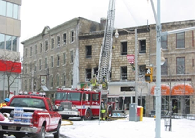 Image of fire trucks dealing with a fire at an old building in downtown Guelph