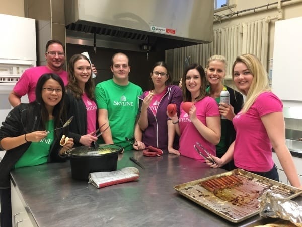 Eight Marketing employees pose for a picture after serving breakfast to Hope House