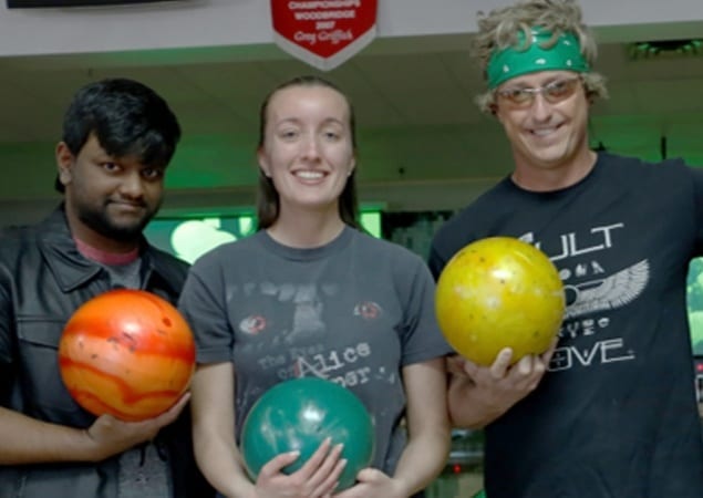 Three Skyline employees in Rock & Roll outfits, bowling to Benefit Big Brothers, Big Sisters of Guelph