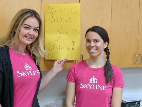 Two female Skyline employees with a Thank You Sign