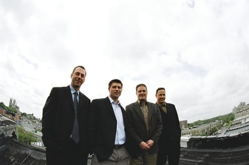 Skyline Co-Founders standing together on a roof overlooking Guelph's downtown